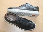 Baskets en cuir noir et semelle blanche