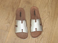 Mules plates en cuir doré Emma